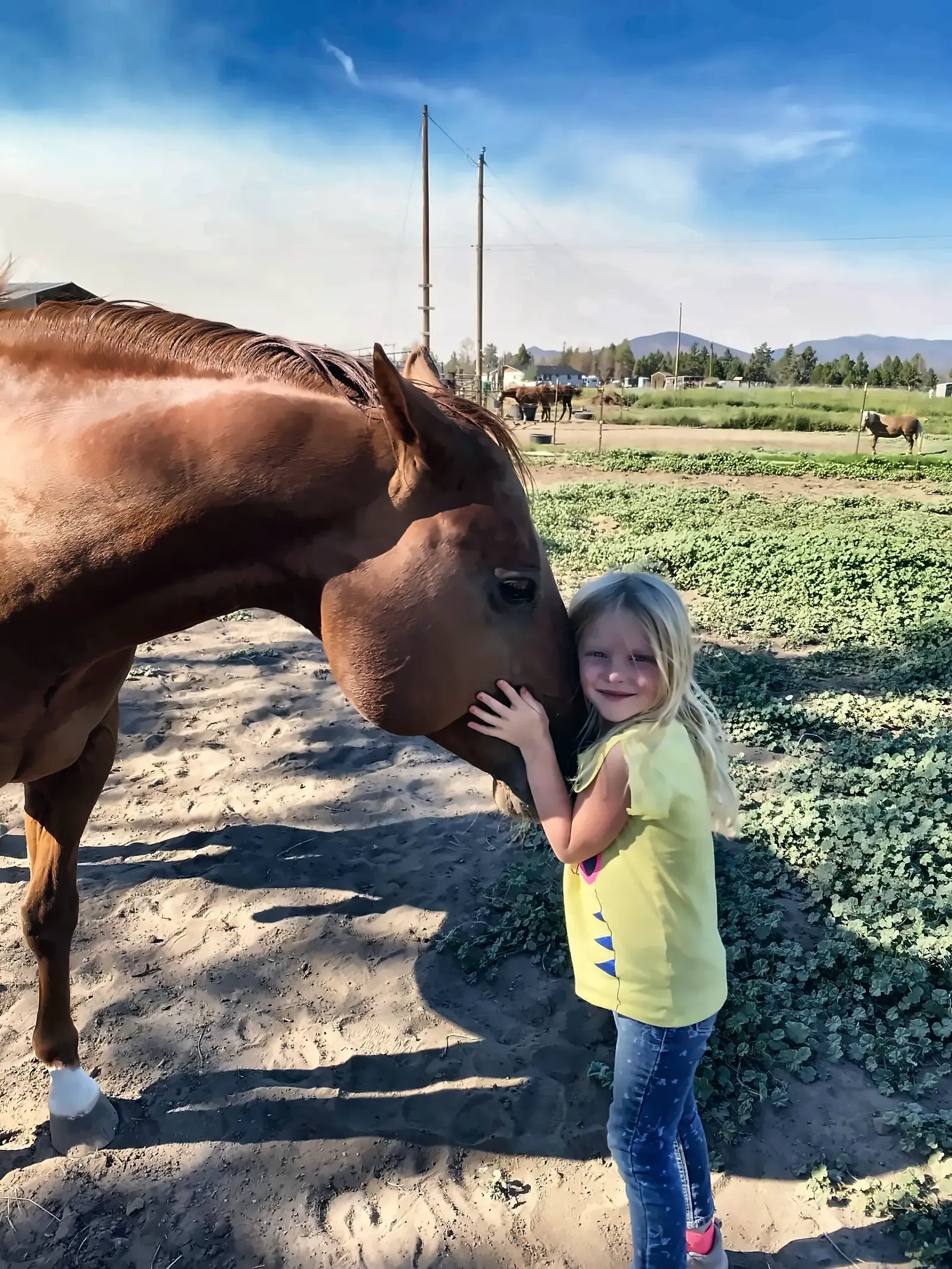 A young girl hugging TK High on Biankus